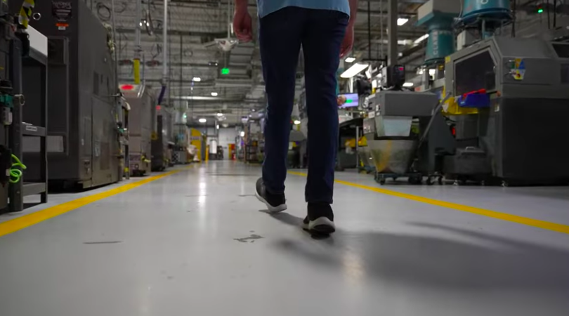 Individual walking through factory